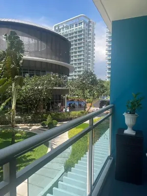 a balcony with a view of a building at Maldives Suites, Azure Urban Resorts and Residences in Manila