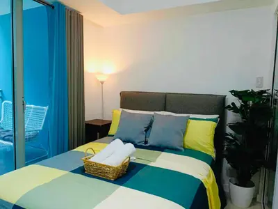 a bedroom with a bed with a basket on it at Maldives Suites, Azure Urban Resorts and Residences in Manila
