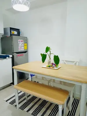 a table with a potted plant sitting on top of it at Maldives Suites, Azure Urban Resorts and Residences in Manila