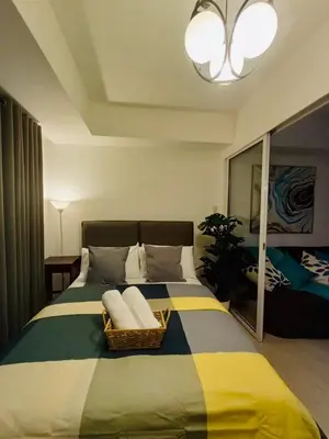 a bedroom with a large bed with a basket on it at Maldives Suites, Azure Urban Resorts and Residences in Manila