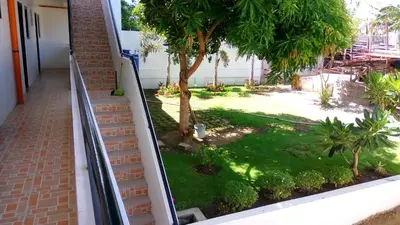a view of a garden from a balcony at The Palines Apartment Hotel near Brittany Palazzo Villar City in Manila