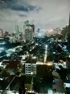 a city lit up at night with buildings at 1 BEDROOM Staycation in Pasay in Manila