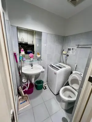 a small bathroom with a toilet and a sink at Sea Residences Tower E in Manila