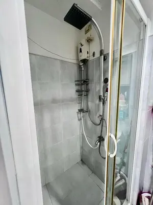 a shower stall in a bathroom with a shower at Sea Residences Tower E in Manila