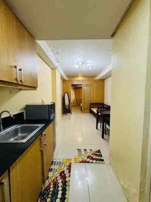 a kitchen with a sink and a counter top at Shell Residences Tower A in Manila