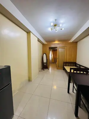 an empty room with a ceiling fan and a dining room at Shell Residences Tower A in Manila