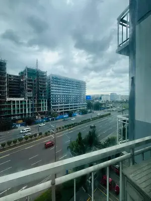 a view of a city with a highway and buildings at Shell Residences Tower A in Manila