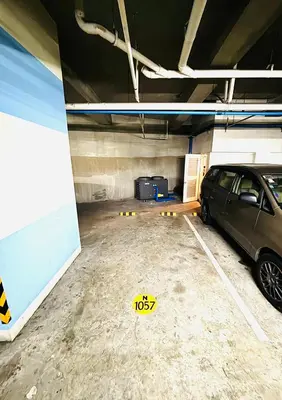 a parking garage with a car parked in it at Free Car Parking - Sheridan North 1BR Apt near BGC in Manila
