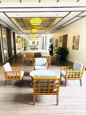 a lobby with chairs and tables in a building at Free Car Parking - Sheridan North 1BR Apt near BGC in Manila
