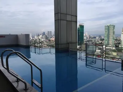 a view of a city from the top of a building at Cozy 1 Bedroom Condo Unit in Manila