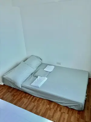 a white bed with two pillows on top of it at Loft in Boni - Work friendly - Cityview - up to 8pax in Manila