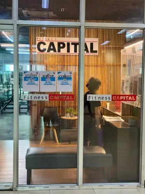 a reflection of a woman in a store window at Loft in Boni - Work friendly - Cityview - up to 8pax in Manila
