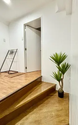 a hallway with a potted plant in front of a door at Loft in Boni - Work friendly - Cityview - up to 8pax in Manila