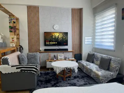 a living room with a couch and a tv at Aras Solace Place in Trece Martires