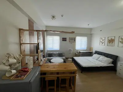 a living room with a bed and a couch at Aras Solace Place in Trece Martires