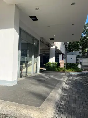 a large white building with a walkway in front of it at Aras Solace Place in Trece Martires
