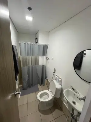 a bathroom with a toilet and a sink at Aras Solace Place in Trece Martires