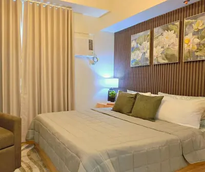 a bedroom with a large bed in a room at The Eve Place Staycation PH in Biñan
