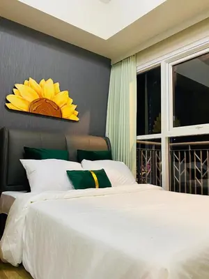 a bedroom with a large white bed and a window at Savvy Suites Combined 6BR near Okada in Manila