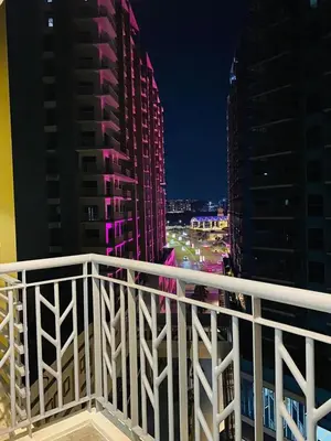 a view of a city at night from a balcony at Savvy Suites Combined 6BR near Okada in Manila