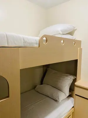 two bunk beds in a room with a pillow at Savvy Suites Combined 5BR near Okada in Manila