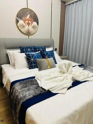 a bedroom with a large bed with towels on it at Savvy Suites Combined 5BR near Okada in Manila