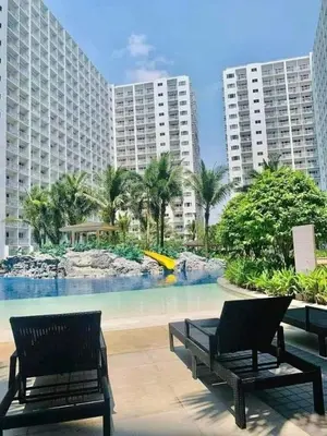 a resort with two benches and a swimming pool at HY Place Manila in Manila