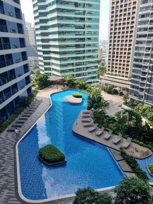 an aerial view of a swimming pool in a city at Air Residences - Elevate Escapes Makati, central location in Manila