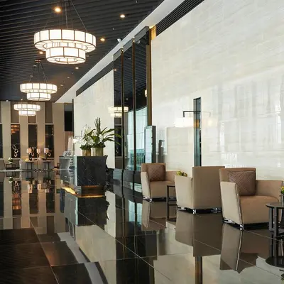a lobby with chairs and tables in a building at Air Residences - Elevate Escapes Makati, central location in Manila