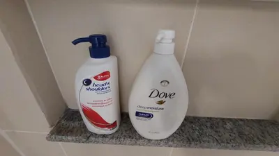 two bottles of detergent sitting on a shelf at Affordable Whole 2 bedroom Condo high floor BGC in Manila