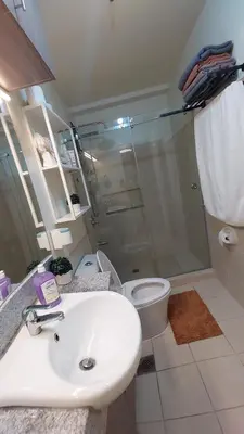 a bathroom with a sink and a shower and a toilet at Affordable Whole 2 bedroom Condo high floor BGC in Manila