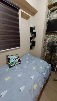 a bedroom with a bed with yellow arrows on it at Affordable Whole 2 bedroom Condo high floor BGC in Manila