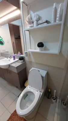 a bathroom with a toilet and a sink at Affordable Whole 2 bedroom Condo high floor BGC in Manila