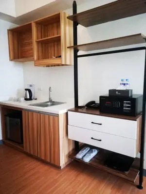 a kitchen with a sink and a microwave at I suites in Manila