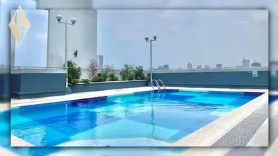 a large blue swimming pool on top of a building at I suites in Manila