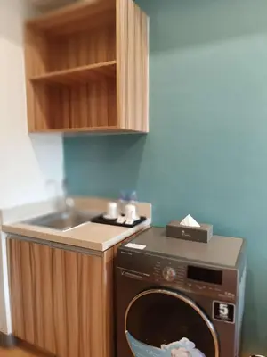 a kitchen with a washing machine and a sink at I suites in Manila