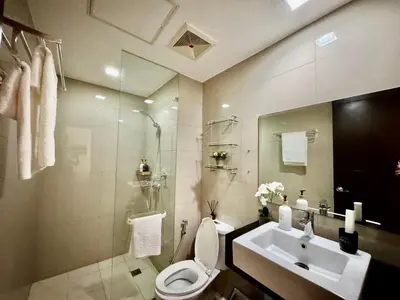 a bathroom with a toilet and a sink at Cozy Home at Venice Luxury BGC in Manila