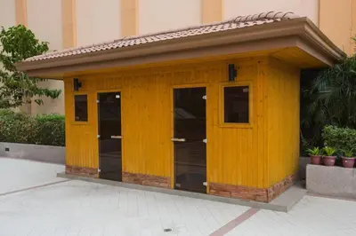 a small yellow building with doors and windows at Cozy Home at Venice Luxury BGC in Manila