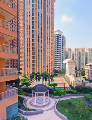 a gazebo in the middle of a city with tall buildings at Cozy Home at Venice Luxury BGC in Manila