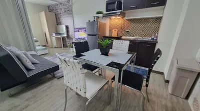 a dining room and kitchen with a table and chairs at Joms Cozy Staycation in Calamba