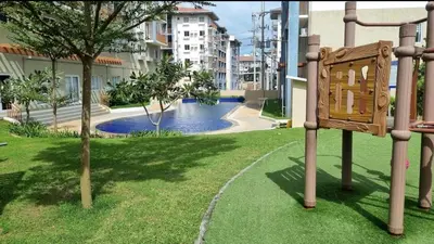 a sign in a park with a swimming pool at Joms Cozy Staycation in Calamba