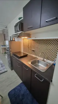 a kitchen with a sink and a counter top at Joms Cozy Staycation in Calamba