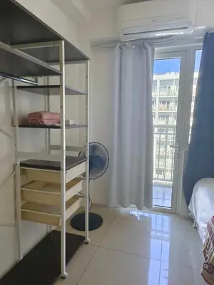 a bedroom with a bunk bed and a window at Shore Condotel Metro Staycation in Manila