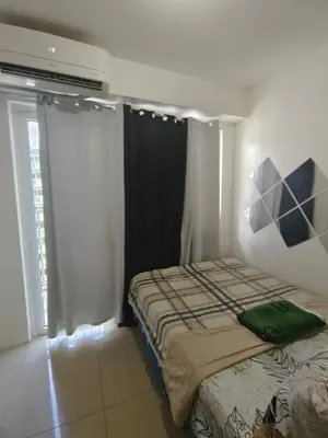 a bedroom with a bed and a window at Shore Condotel Metro Staycation in Manila