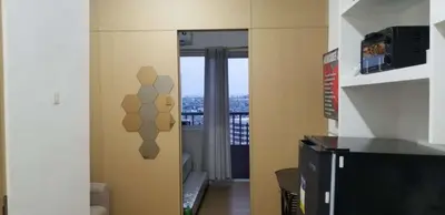 a room with a door with a view of a balcony at VM Staycation Tower 3 Grace Residence Taguig in Manila
