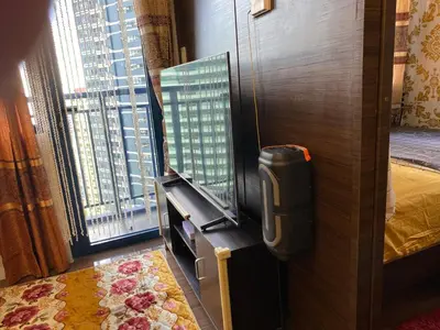 a room with a tv and a large window at Family Oasis Makati 2 bedroom 1 kiddo room 300 mbps Fast Net in Manila