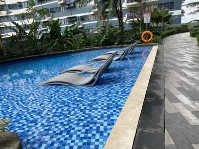 a swimming pool with escalators in the middle of a building at Family Oasis Makati 2 bedroom 1 kiddo room 300 mbps Fast Net in Manila