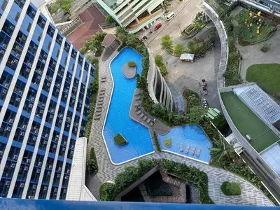 an overhead view of a pool in front of a building at Family Oasis Makati 2 bedroom 1 kiddo room 300 mbps Fast Net in Manila