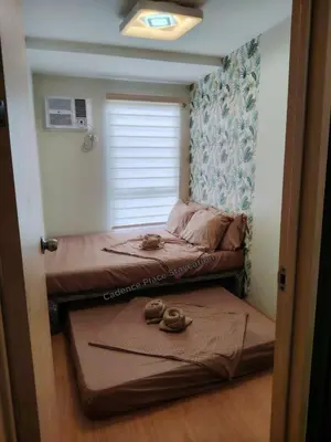 a room with two beds and two pairs of shoes at Cadence Place 2BR Pasig Condo for upto 6pax with Free Parking in Manila