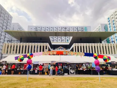 a market with colorful umbrellas in front of a building at Cadence Place 2BR Pasig Condo for upto 6pax with Free Parking in Manila